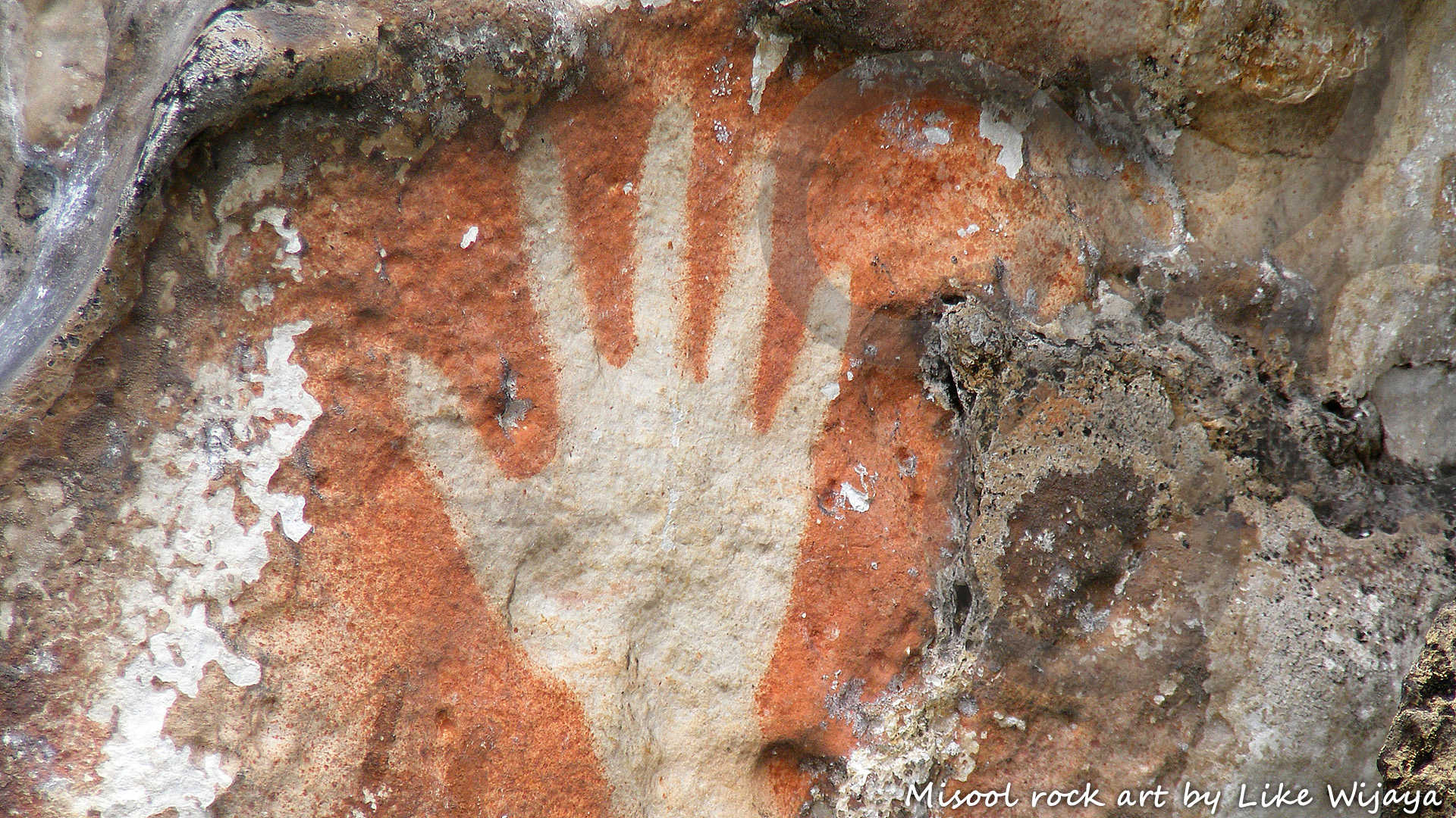 Rock art, including timeless so-called 'stencilled hands', off Misool Island in the fabled Raja Ampat archipelago off New Guinea's western tip, is being associated with the first wave of human expansion into the New Guinea region. Copyright © Like Wijaya